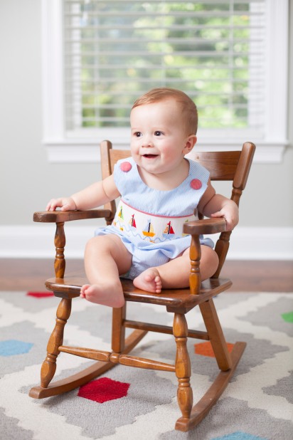 Six-month-old boy sits in a rocking chair
